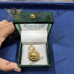 GOLD TONED SUNBURST PENDANT WITH CENTRAL SYMBOL